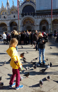 Children feeding the pigeons in Venice